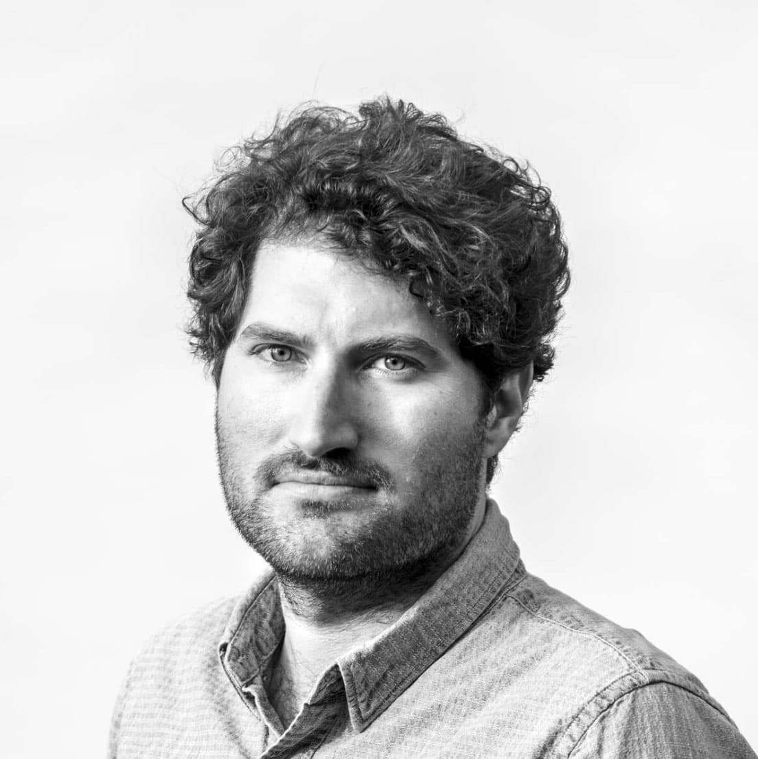 B&W portrait of Peter Van Agtmael wearing a collared button down shirt