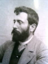 B&W photo of Vittorio Sella looking to the left, wearing a blazer